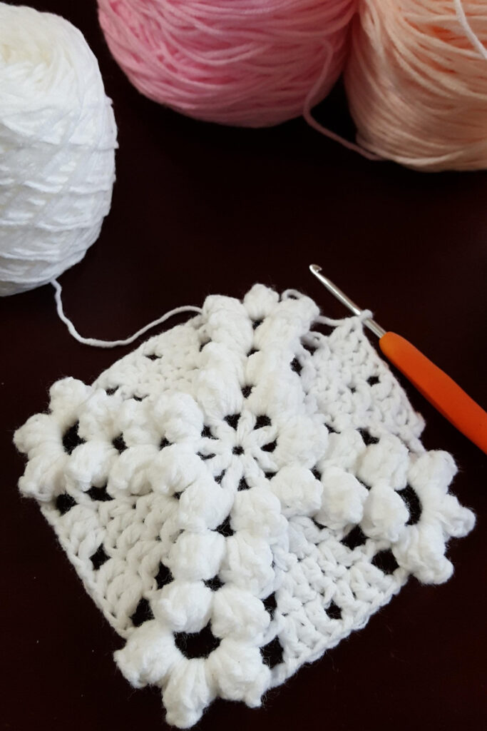 A white crochet granny square.
