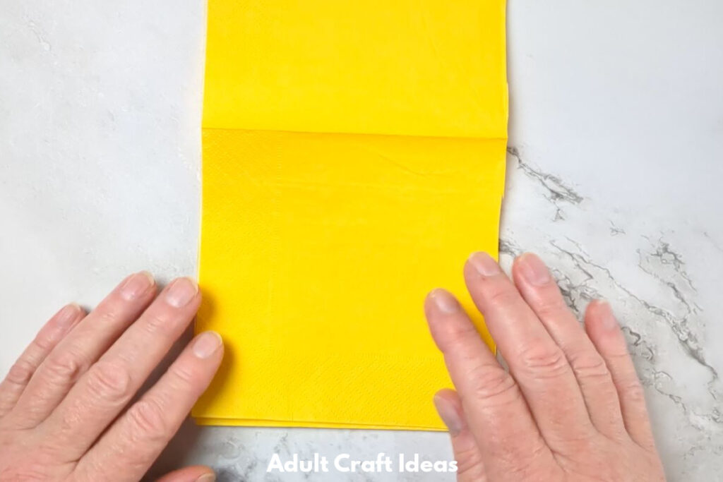 Yellow paper and two hands.