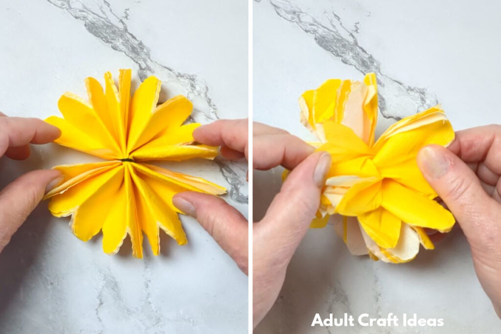 Hand holding a paper flower.