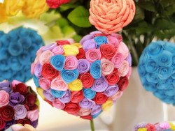 A decorative heart made with fabric flowers.